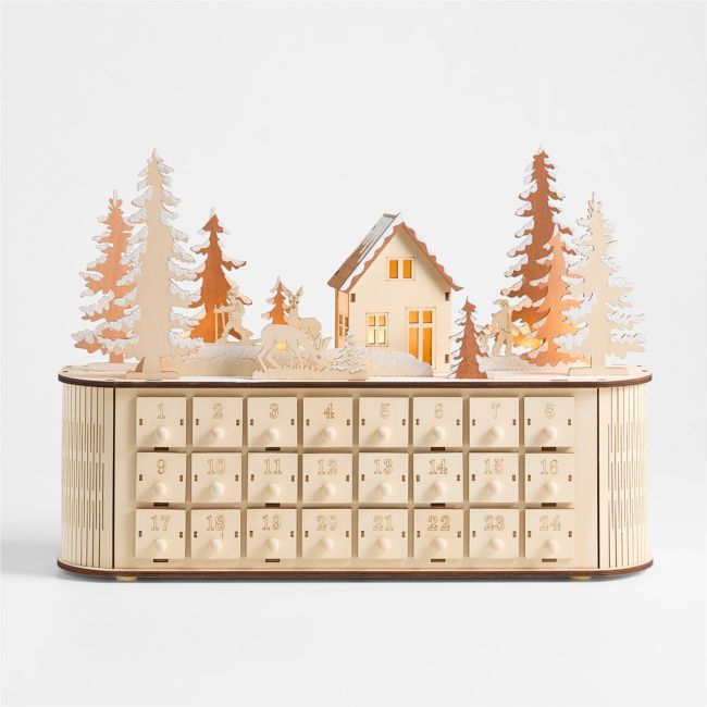 a wooden box with a house and trees on it