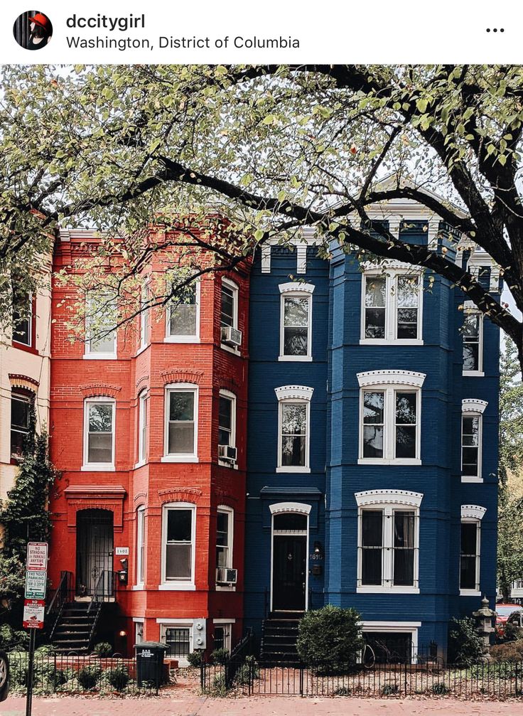 several multi - colored houses are lined up on the street in front of each other