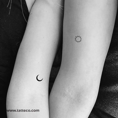 two people with matching tattoos on their arms, one has a sun and the other has a moon