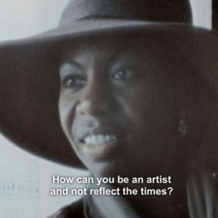 a woman wearing a black hat with the words how can you be an artist and not reflect the times?