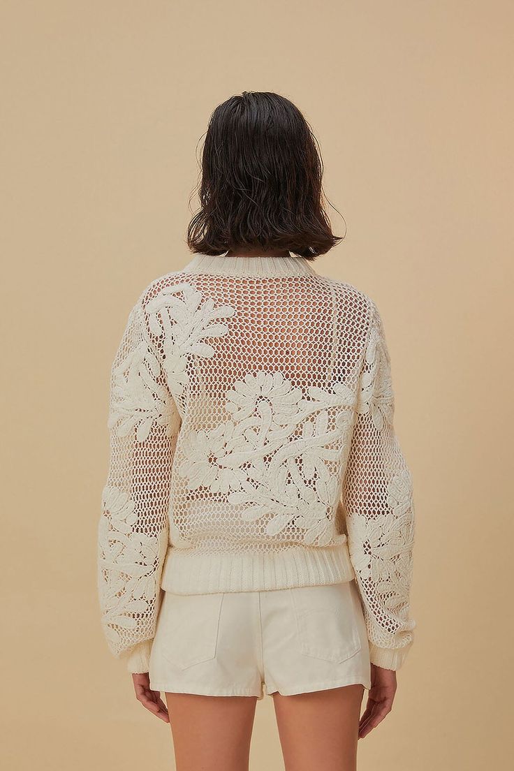 the back of a woman's sweater and shorts