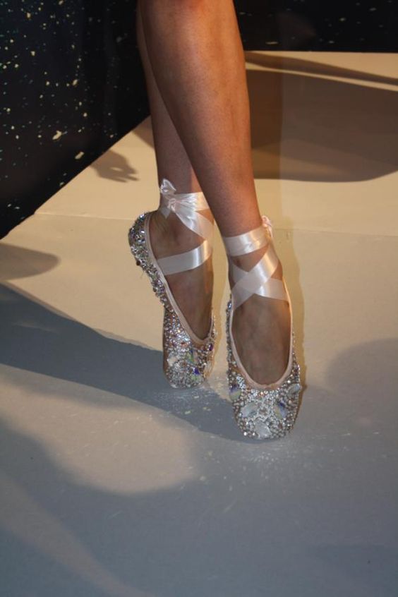 a woman's feet in high heels on the runway