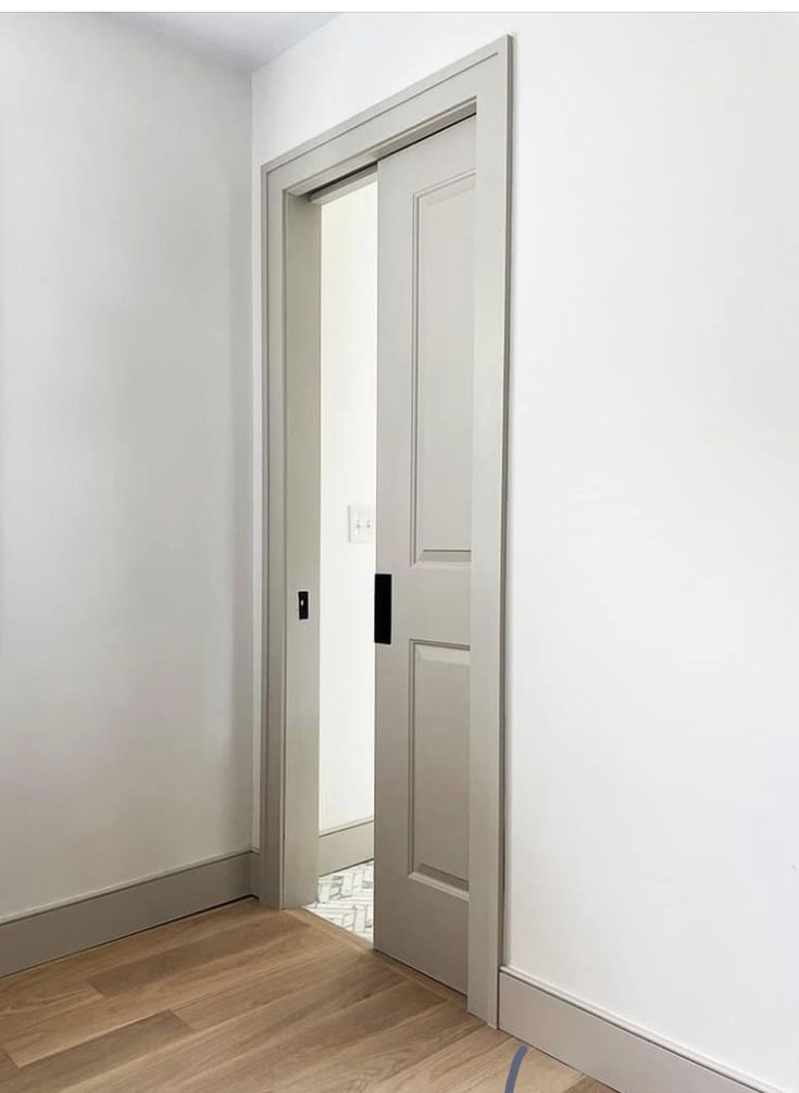 an empty room with white walls and wood flooring is pictured in this image from the doorway