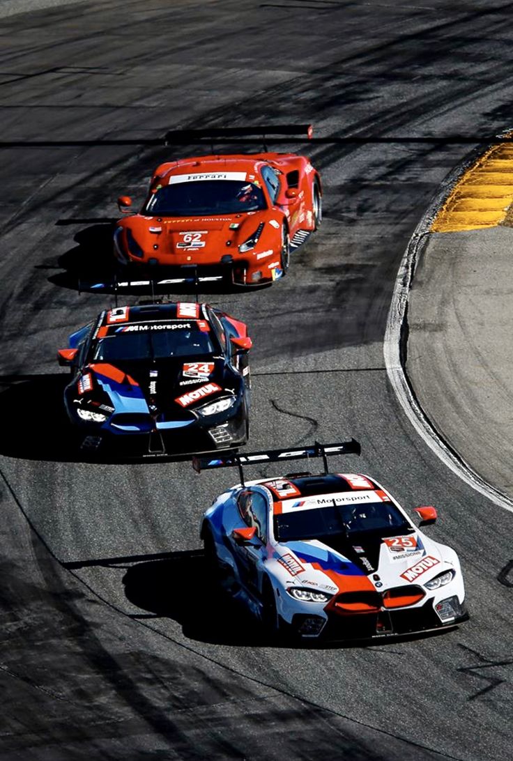 three racing cars on a race track