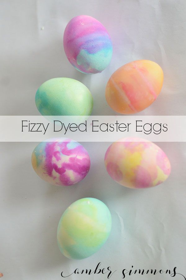 five dyed easter eggs in different colors on a white background with the words fuzzy dyed easter eggs