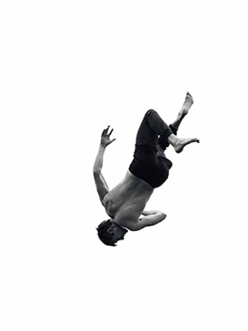 a man diving in the air with his hands up