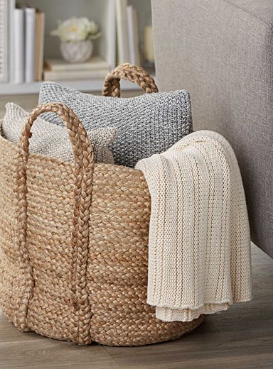 a basket with some blankets on top of it