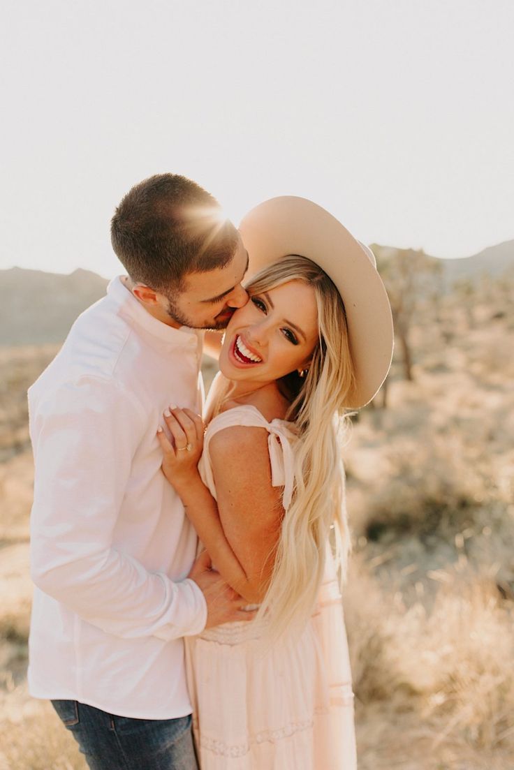 a man and woman hugging in the desert