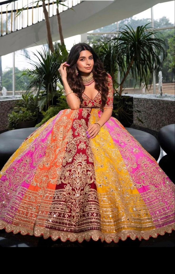 a woman in a colorful dress posing for the camera