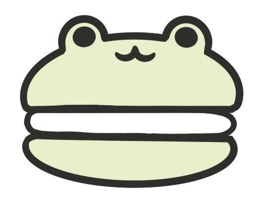 a cartoon frog sitting on top of a white plate