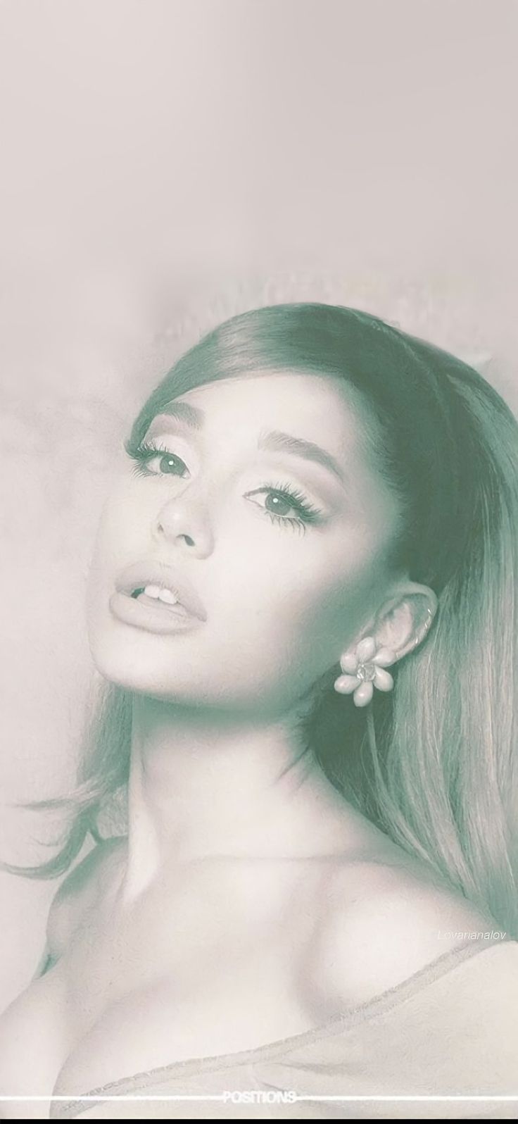 a woman with long hair and earrings posing for a photo in front of a white frame