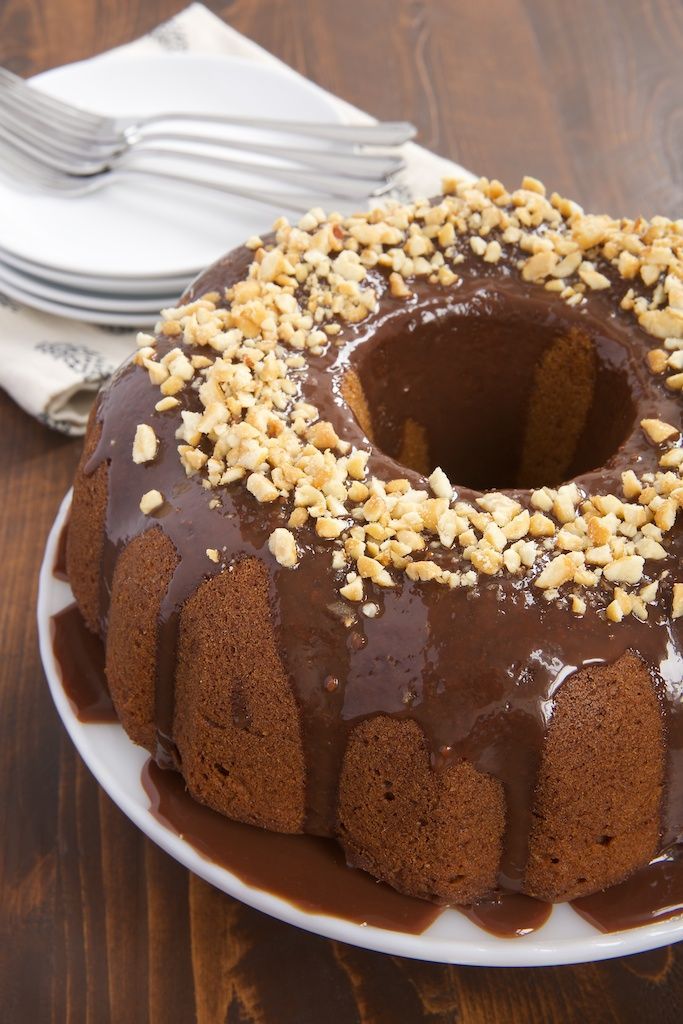 a chocolate bundt cake with nuts on top