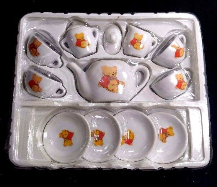 a white tray with winnie the pooh tea set in it