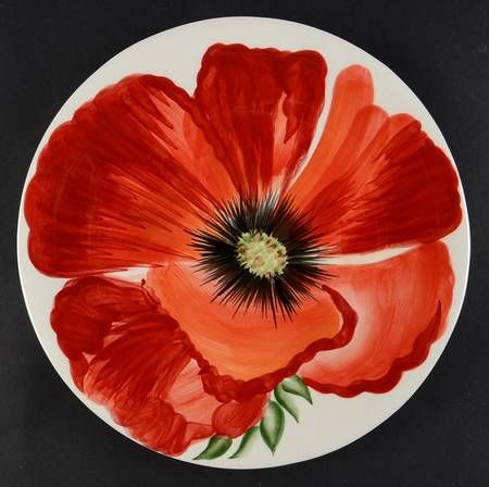 an orange and red flower painted on a white plate with green stems in the center