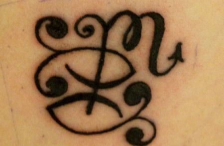 a close up of a tattoo on the back of a person's upper arm