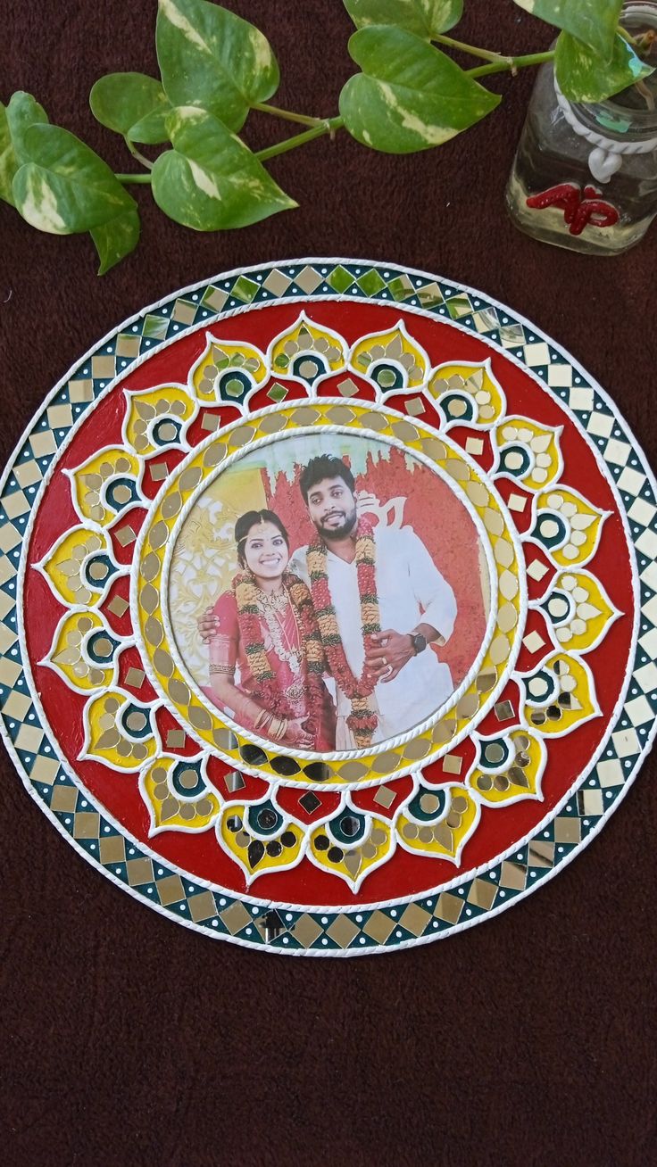 a plate with an image of two people on it next to a potted plant