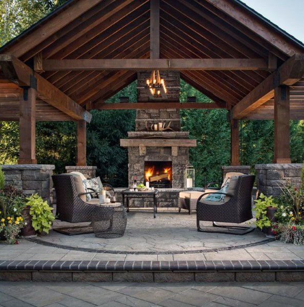 an outdoor living area with furniture and a fire place