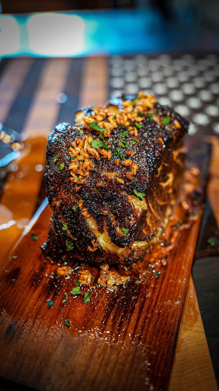 a piece of meat sitting on top of a wooden cutting board