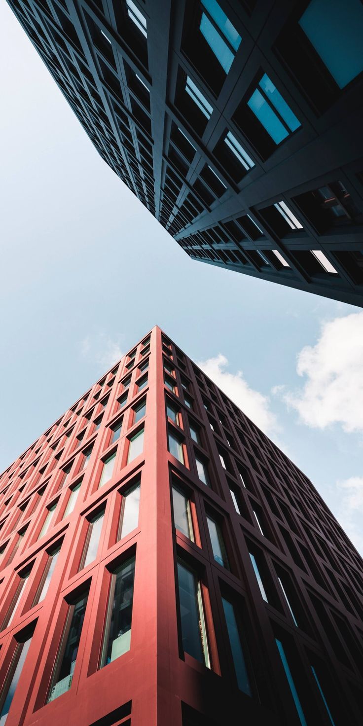 looking up at the side of a tall red building