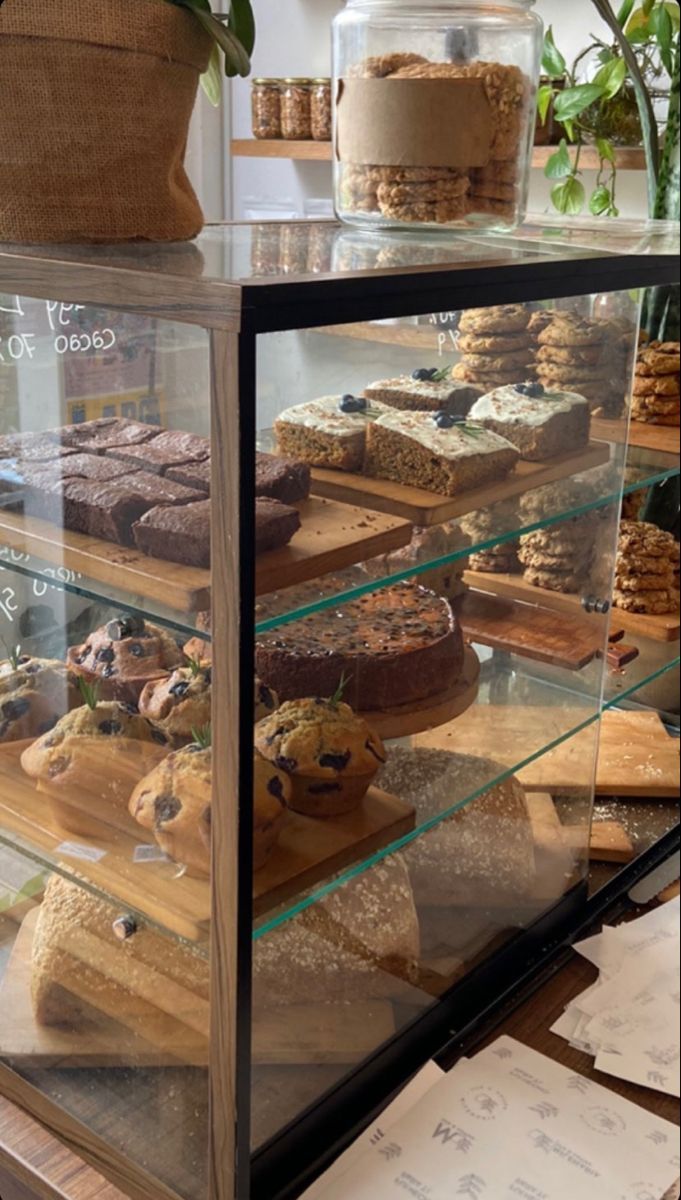 a display case filled with lots of cakes and pastries