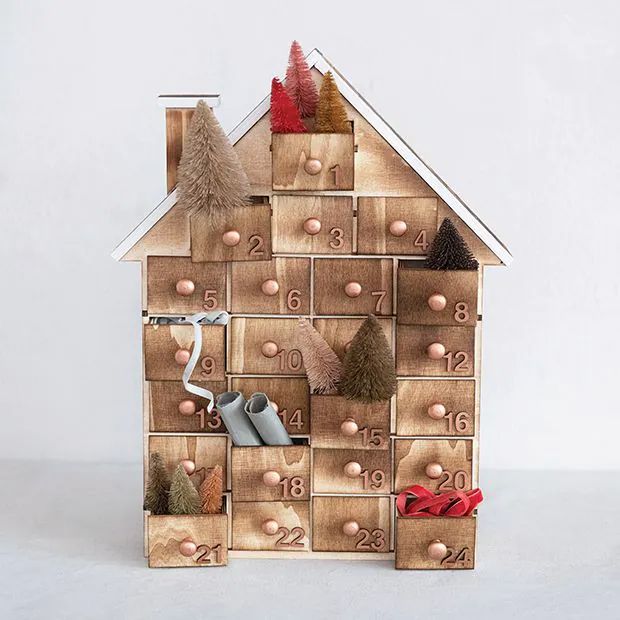 a house made out of wooden boxes with shoes on the front and numbers on the outside