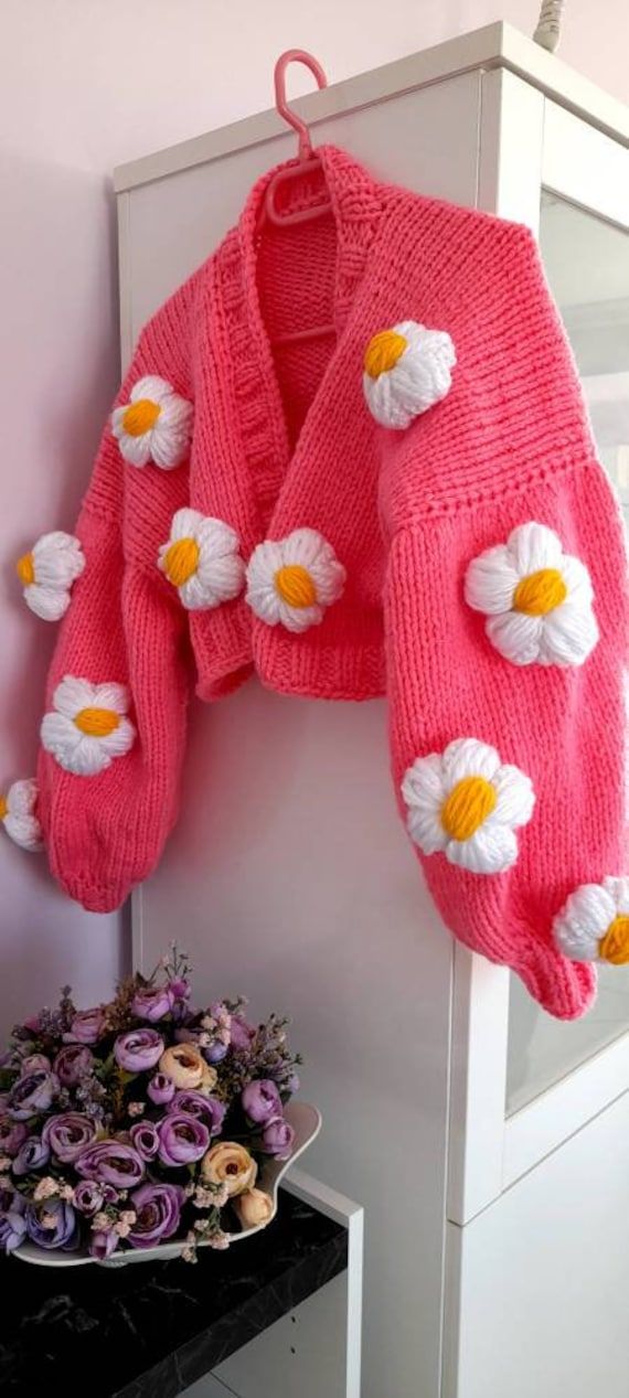 hand knitted crop daisy cardigan with quality yarns that you can wear for years It is knitted, princess sleeve floral pink knit cardigan has been knitted with non-fading threads for many years, daisy knit jacket was originally hand knitted by me. You can give it as a gift to your girlfriend, a gift to your wife on your wedding anniversary, or a gift to your mother on mother's day, which will make you feel special. I can knit in any color and size you want. Please contact us to order. Size : ONES Spring Crochet Acrylic Sweater, Spring Acrylic Crochet Sweater, Spring Knitted Acrylic Sweater, Hand Knitted Acrylic Sweater For Spring, Hand Knitted Acrylic Outerwear For Spring, Cute Hand Knitted Spring Cardigan, Cute Spring Knit Sweater, Spring Hand Knitted Acrylic Cardigan, Pink Embroidered Long Sleeve Cardigan