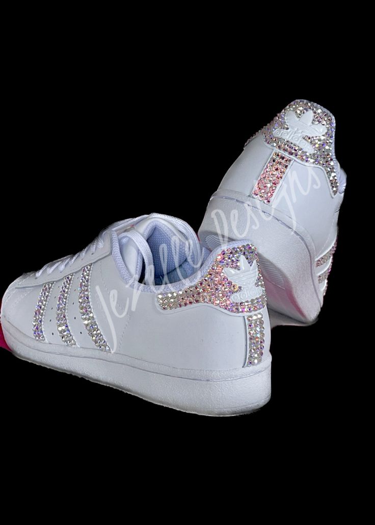 🌟 Sport Luxe Kicks! 🌟 Our Original Crystal Design! Custom Hand Jeweled with PREMIUM SWAROVSKI CRYSTALS by Jezelle Designs. 💎SHOE COLOR for this listing:  ALL White    ANY and ALL colors may be available in your size!  See pics above for examples. Message for a custom order. for these or any colors you'd like.  💎CRYSTAL COLOR:  AB (Aurora Boreale) an iridescent color. Other crystal colors, sneaker colors & style options are available. Message if interested. SEE our >>. @bling.vegas INSTAGRAM for other color options, i.e.  black/gold. 💎SIZES: Sold in Women's sizes. 💎 Crystal placement: As shown above on pics 1-3:  ALL 4 SIDES (3 stripes on the inner 2 sides + the outer 2 sides) +HEELS + the LACES STRIP on the tongue.  💎  Hand Jeweled one crystal at a time, with precision and care, and Blinged Out Sneakers, Diy Rhinestone Shoes, Jeweled Sneakers, Custom Adidas Superstar, Bejeweled Shoes, Vegas Instagram, Rhinestone Sneakers, Embellished Sneakers, Bedazzled Shoes