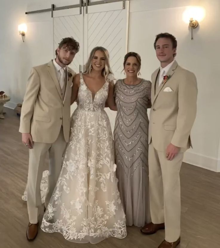 three people standing next to each other in formal wear