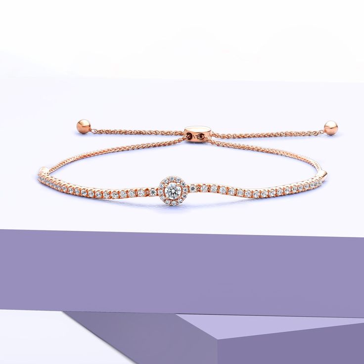 The Signature Round Halo Bolo Bracelet is a minimalist's dream. This diamond bracelet showcases a round diamond centerpiece encircled by a halo of tiny round diamonds. Its solid gold chain also sparkles with tiny diamonds, adding a touch of elegance to any outfit. The bolo clasp allows for adjustable sizing, ensuring a perfect fit for every wrist. Elegant Diamond Bracelet With Adjustable Chain, Rose Gold Bracelet With Diamond Accents, Minimalist Gold Bracelet With Brilliant Cut, Fine Jewelry Cubic Zirconia Chain Bracelet, Formal Bracelet With Halo Setting, Minimalist Bracelet With Brilliant Cut, Diamond Bracelets With Halo Setting In Fine Jewelry, Fine Jewelry Diamond Bracelets With Halo Setting, Diamond Bracelets With Halo Setting