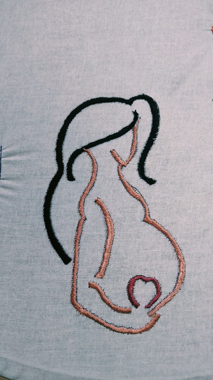 a woman's breast embroidered onto a t - shirt