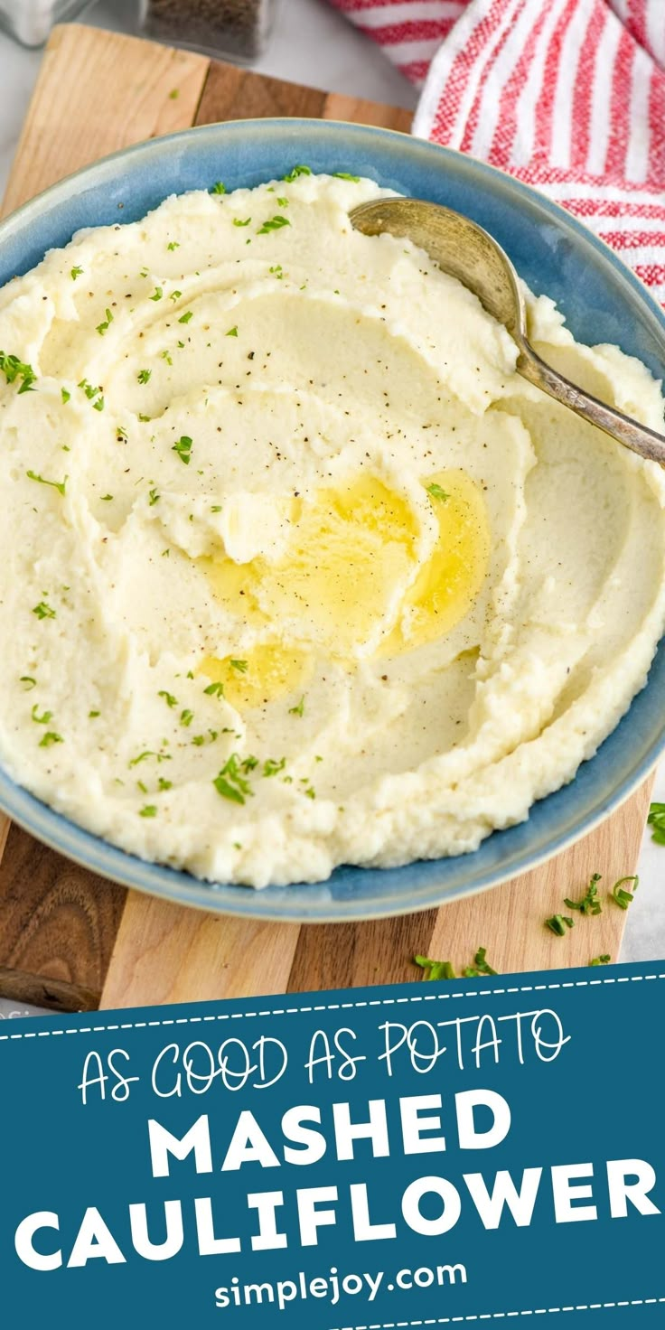 mashed cauliflower in a blue bowl with a spoon