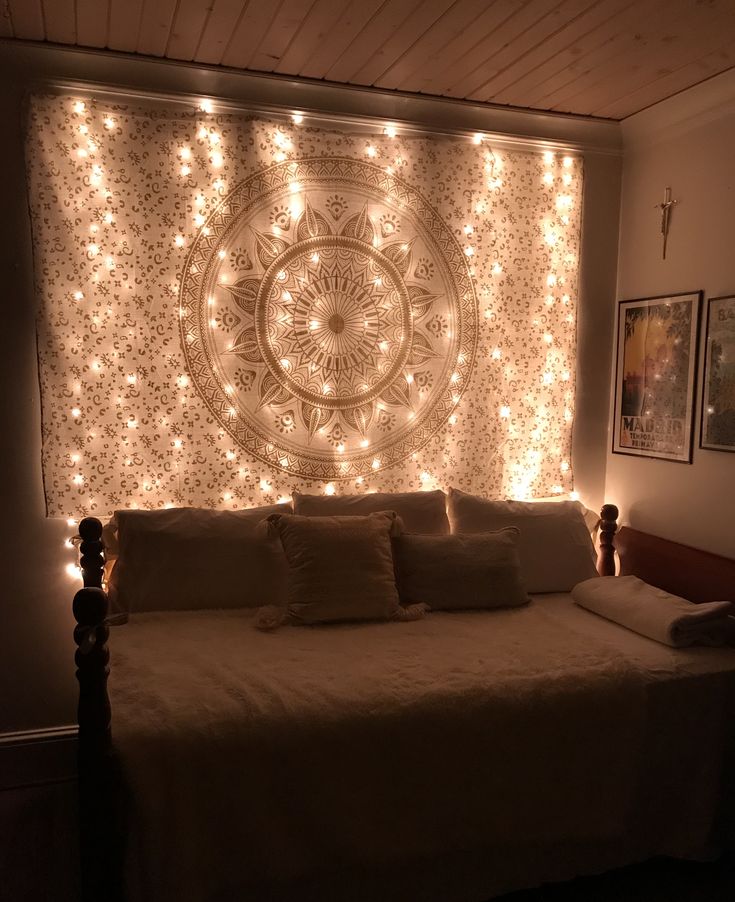 a bedroom with lights on the wall and a bed