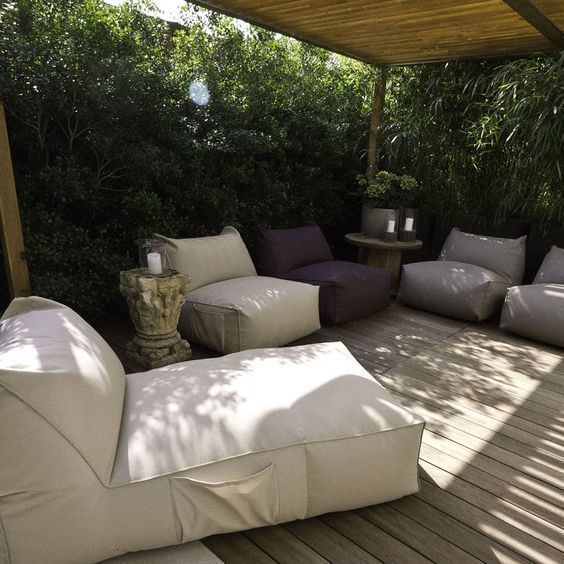 an outdoor living area with couches and tables