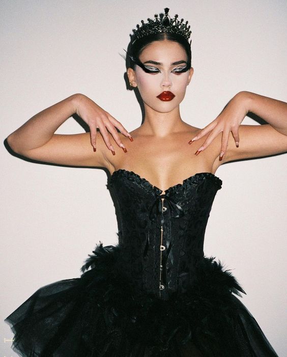 a woman wearing a black corset with her hands on her hips