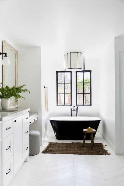 a black and white bath tub sitting in a bathroom