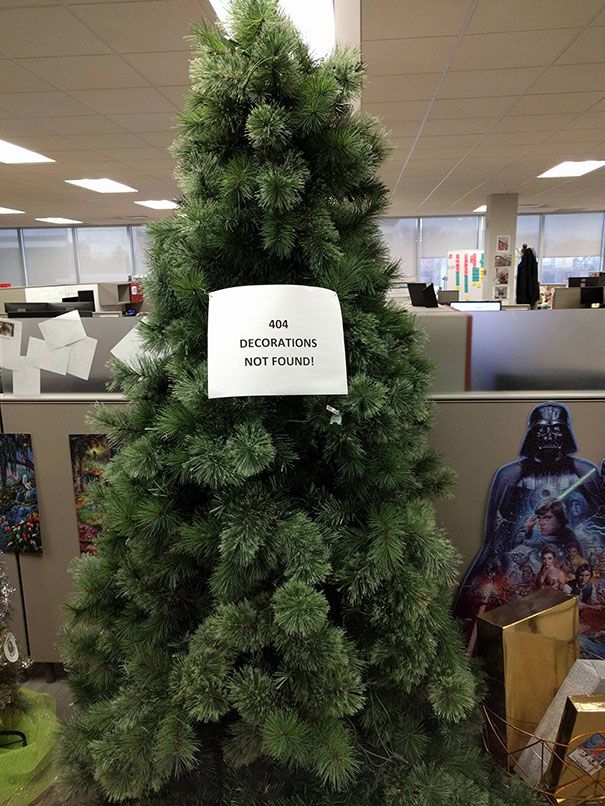 a fake christmas tree in an office cubicle with star wars decorations on the wall