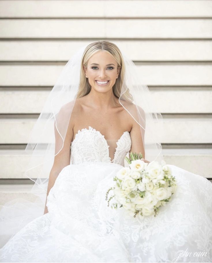 a woman in a wedding dress holding a bouquet