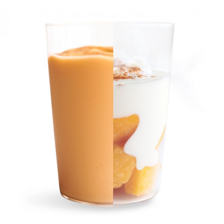 a glass filled with milk and orange slices