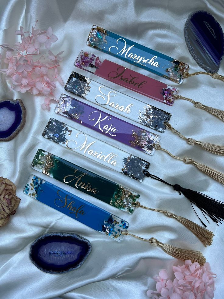 the nameplates on the table are decorated with flowers and other decorative items, such as feathers