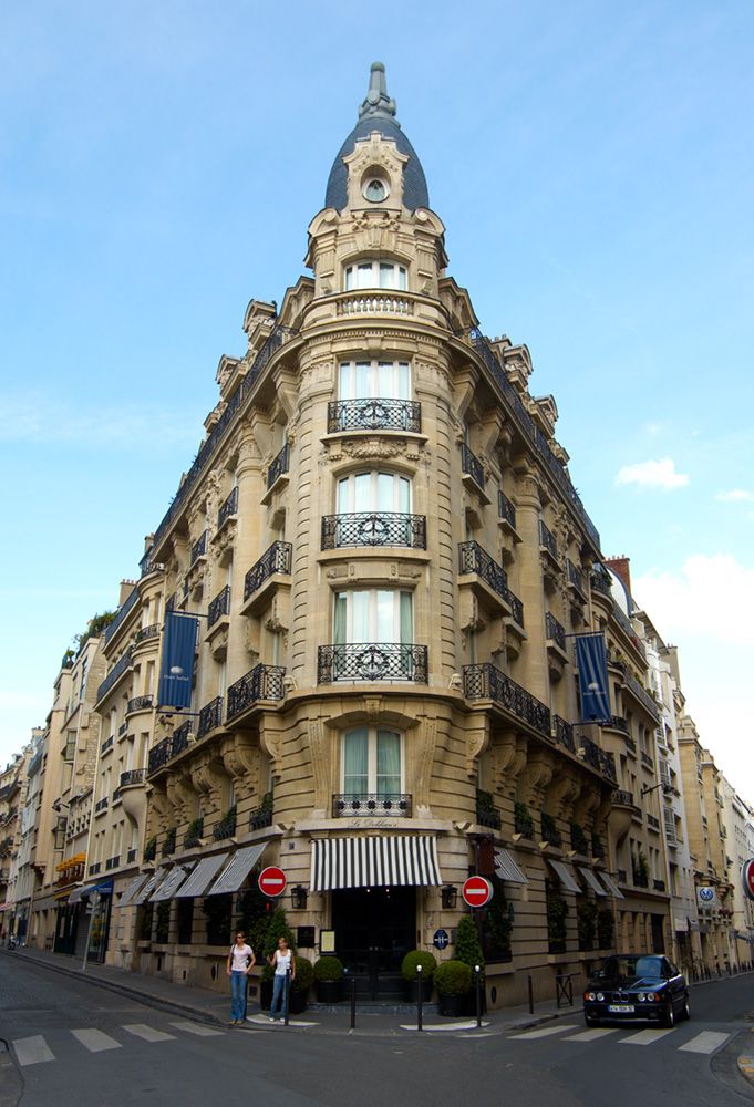 a very tall building sitting on the side of a road