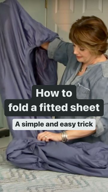 a woman is sitting on the floor with a sheet in front of her and text that reads, how to fold a fitted sheet