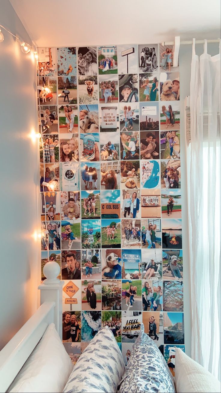 a bed with pillows and pictures on the wall