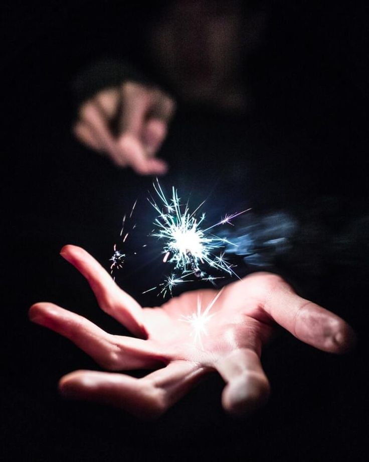 someone holding out their hand with a sparkler in it