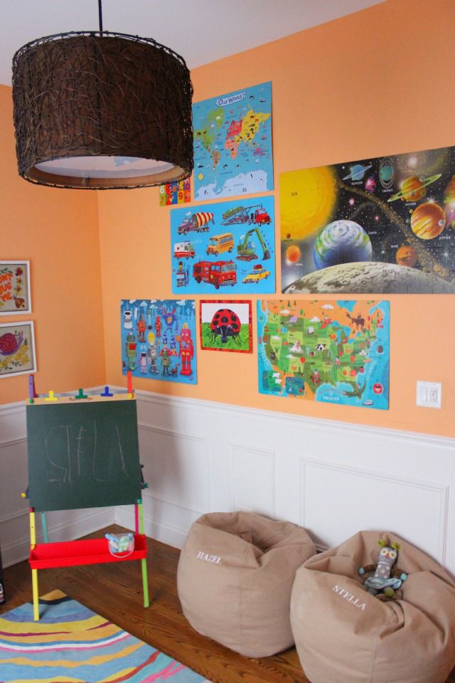 a child's room with bean bag chairs and pictures on the wall