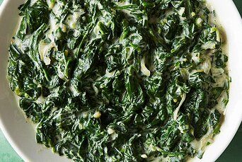 closeup of green leafy vegetables with water droplets on them