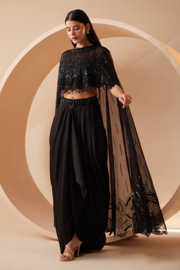 Black asymmetric drape attached cape with all over tonal sequin work. Paired with a dhoti pant and sequin work belt. Components: 3 Pattern: Embroidery Type Of Work: Sequins, Cutdana Neckline: Round Neck Sleeve Type: Drape Sleeves Fabric: Cape: Net, Dhoti Pant: Modal Satin Color: Black Other Details:  Crystal lace on cape Occasion: Cocktail - Aza Fashions Black Dhoti, Cape Set, White Lehenga, Draped Saree, Tuxedo Accessories, Crystal Lace, Women Kurta, Work Belt, Pant Women