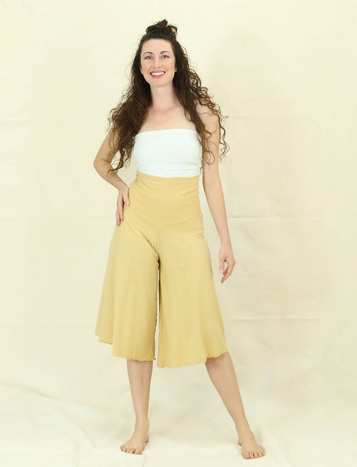 The Wanderer is a flowy, wide-leg design, creating a comfortable yet flattering silhouette. Waistband can be worn high waisted or folded over. Garment Fabric: Light Hemp/Organic Cotton Knit - A hemp and organic cotton blended light-weight knit fabric that has a slight nubby texture, amazing drape, and great durability. This fabric makes an excellent choice for year-round flexibility and laid back luxury. Can be slightly sheer in Natural. 55% Hemp, 45% Organic Cotton. Weight: 5 oz. per yard Waist Spring Beige Yoga Bottoms, Spring Yoga Beige Bottoms, Beige Yoga Bottoms For Spring, Casual Wide Leg Pants For Spring, Summer Stretch Wide-leg Culottes, Summer Casual Stretch Culottes, Stretch Casual Culottes For Summer, Fitted Wide-leg Summer Culottes, Versatile Summer Wide Leg Pants Full Length