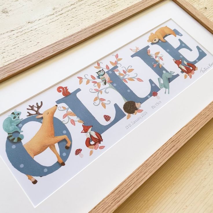 a wooden frame with the word dad written in blue and surrounded by animals, leaves and acorns