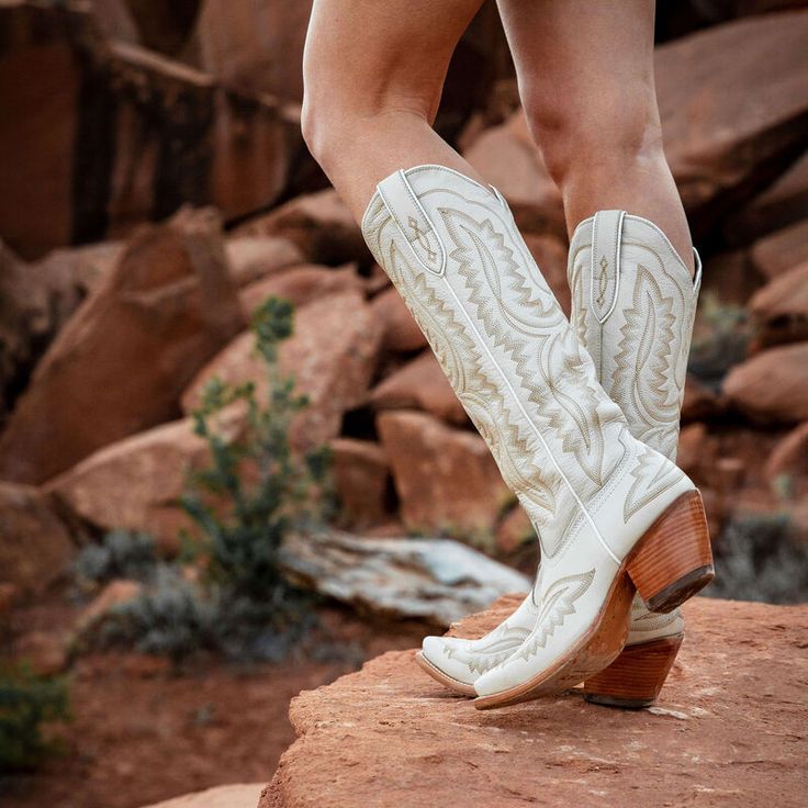 Gorgeous stitching, premium leather, and the knee height make our best-selling Casanova boot a showstopper wherever it goes. With the comfort you need for long nights boogying at country concerts and twirling on the dance floor, it'll turn heads whether you've paired it with cutoffs or your favorite summer dress. ATS® technology provides ergonomic support on uneven terrainVeg-tan leather soleResoleable Goodyear leather welt constructionSix-row stitch patternInside zip for easy entry 16" heightNe Ariat Western Boots, Ariat Boots, Leather Western Boots, Western Boot, Sweater Set, Perfect Shoes, Mens Graphic Tee, Western Wear, Western Boots