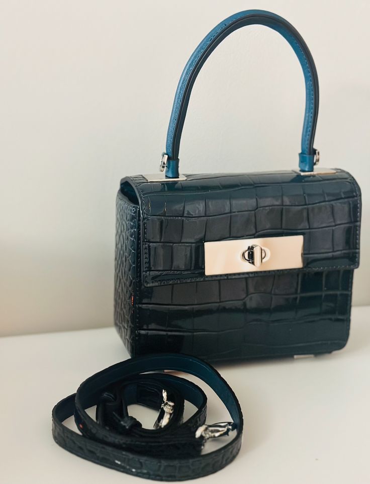 The Blue leather handbag is a stylish blend of sophistication and glamour. It is crafted with genuine leather with attention to details. Dimensions: (LxW): 7.09 inches x 2.76 inches x 5.51 inches Material: 100% Leather Features: Lock closure, Detachable leather strap Estimated Delivery: 3-4 Days High-end Blue Crossbody Shoulder Bag, High-end Blue Box Bag For Everyday Use, High-end Blue Box Bag For Daily Use, High-end Blue Box Bag For Shopping, High-end Blue Shoulder Bag With Detachable Strap, Blue Square Leather Box Bag, Designer Blue Square Satchel, Luxury Satchel Box Bag With Adjustable Strap, Designer Blue Box Bag For Office